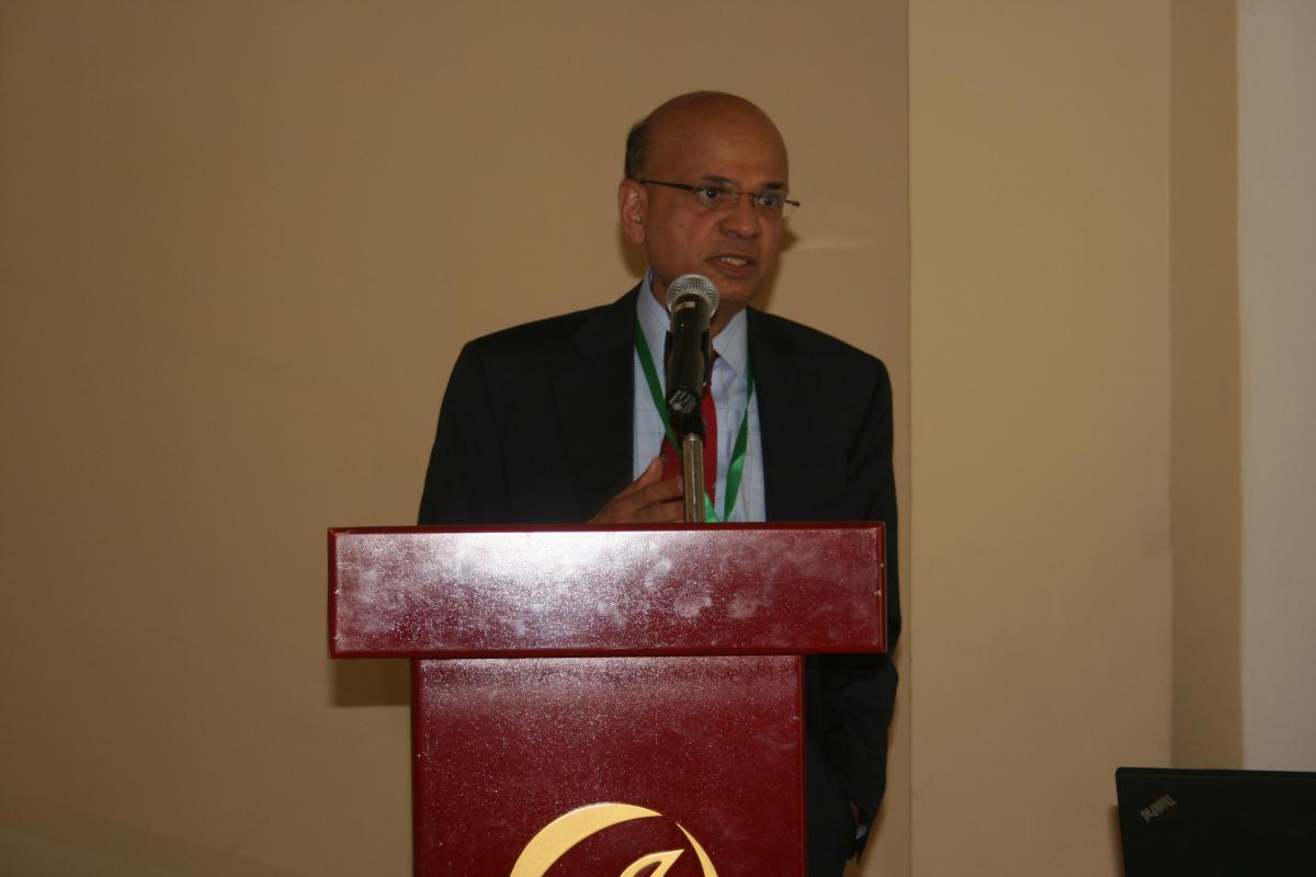 Mr. Gupta speaking at a podium 