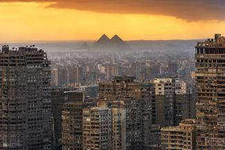 a birds eye view of a city in Egypt with a beautiful yellow sunset.