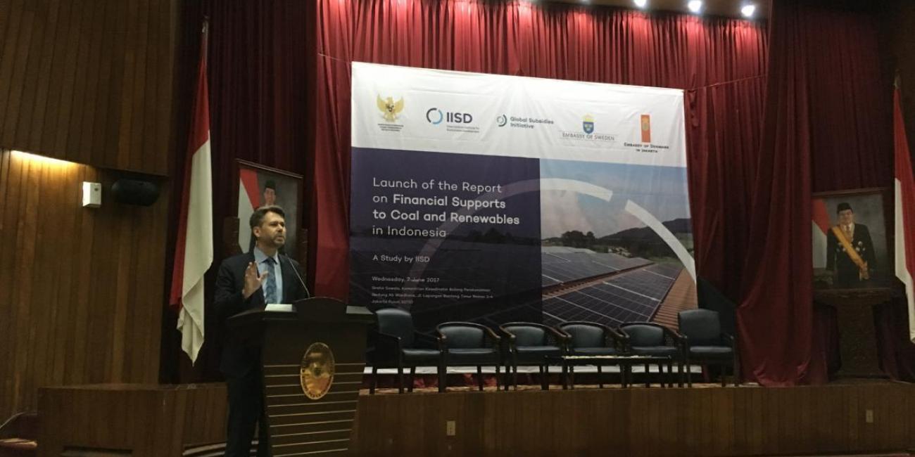 Man speaking at the event, "The True Cost of Coal and Renewables in Indonesia"