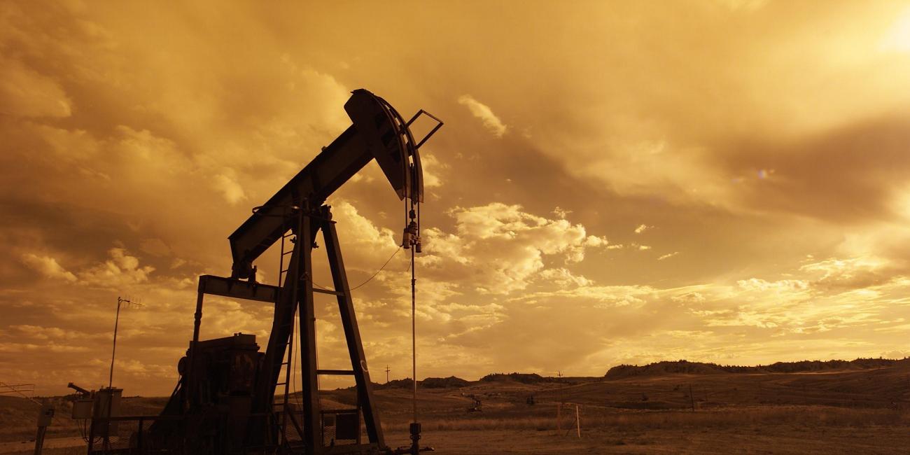 An outdoor shot of an oil-rig, set in a sepia tone.