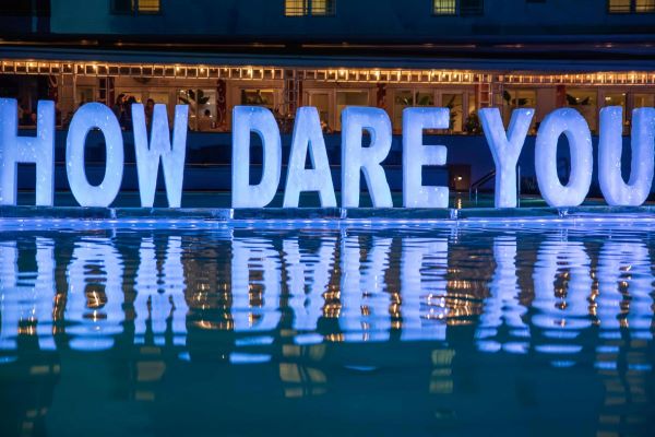 Melting ice sculpture of the words "How Dare You" by Rubem Robiard, example of climate art