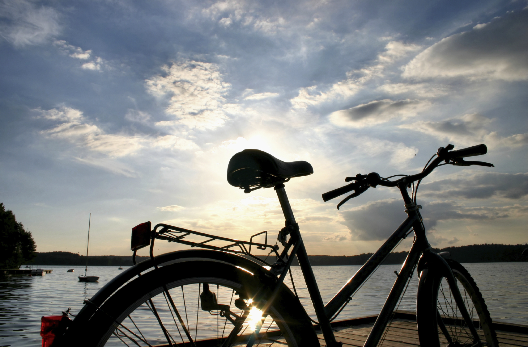 Silhouette of bycicle against lake