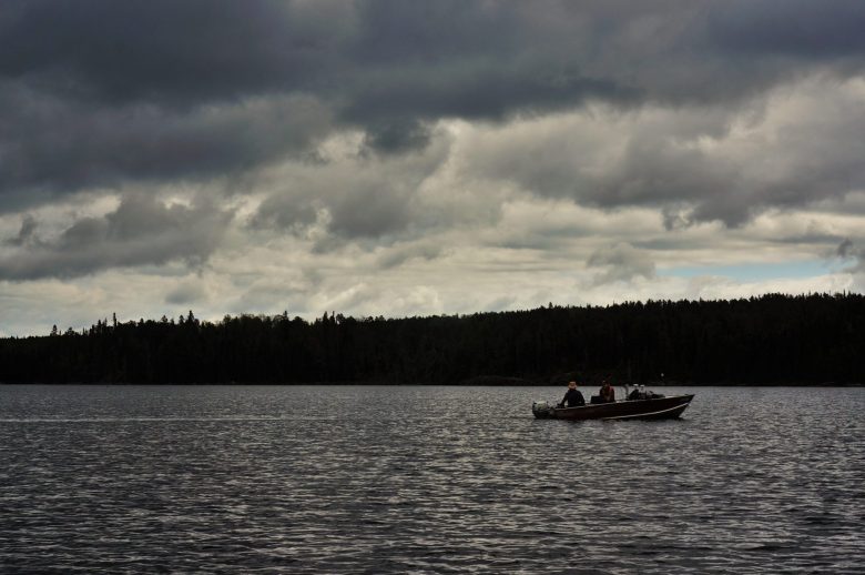 researchers out on a boat on a lake at IISD Experimental Lakes Area in Ontario