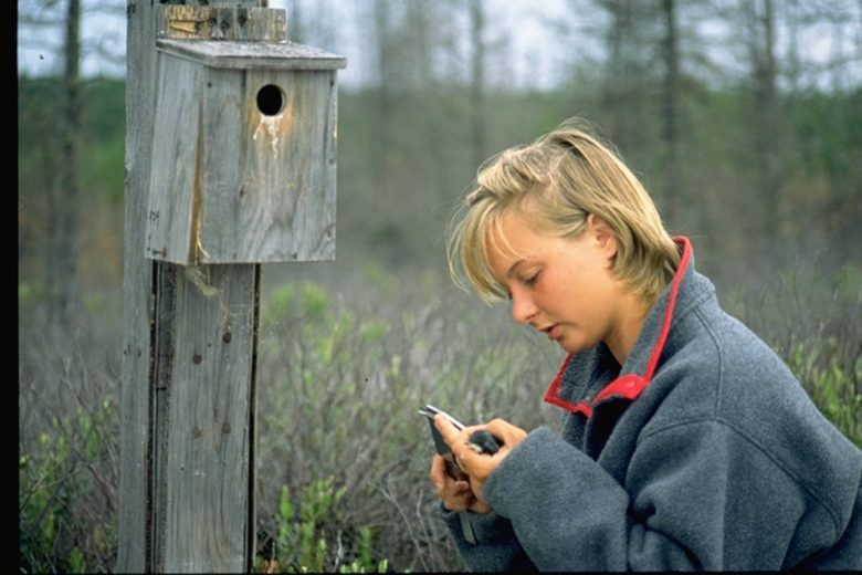 Pauline Gerrard holding a bird at the Experimental Lakes Area