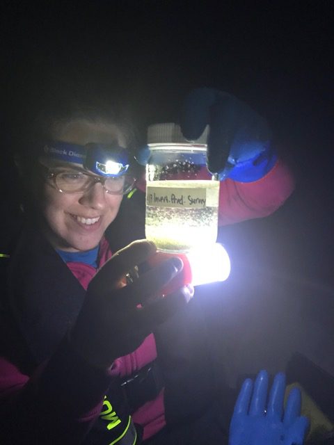A research scientist looks at a water sample at night at IISD Experimental Lakes Area in Ontario