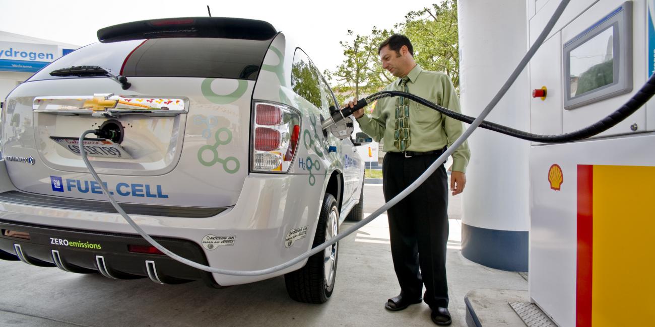Man refueling a hydrogen fuel cell car