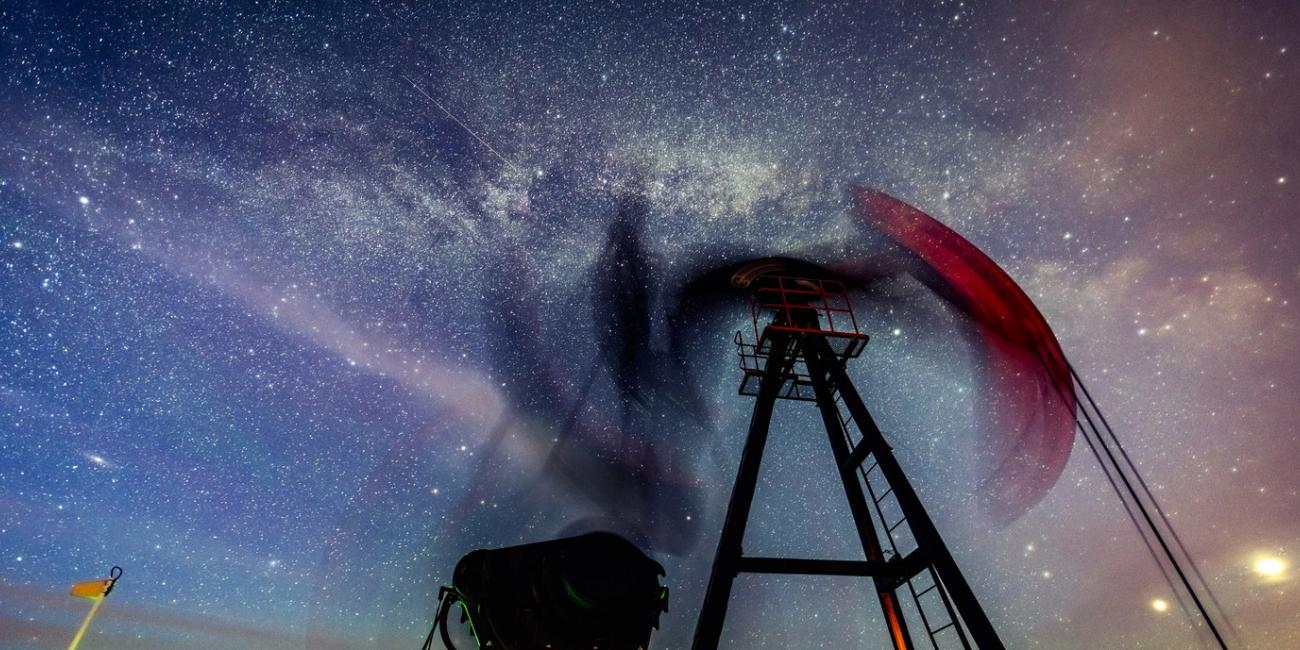 An oil pump in front of a starry night sky.