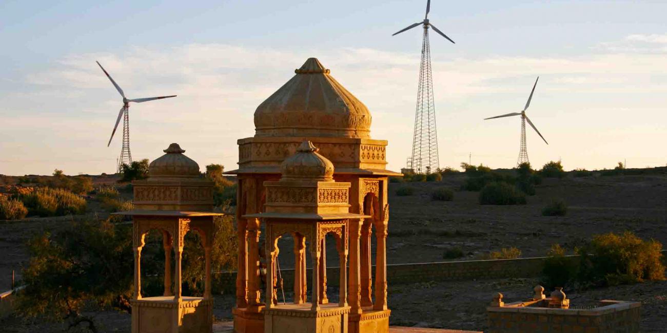 Bada Bagh, Big Garden stands in the foreground while wind turbines stand in the distance.