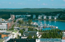City buildings and boats are seen along the skyline of a Finnish city.