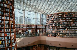 Books line the shelves of a large library.