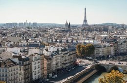 High-rise buildings and the Eiffel Tower are seen along the Paris skyline.