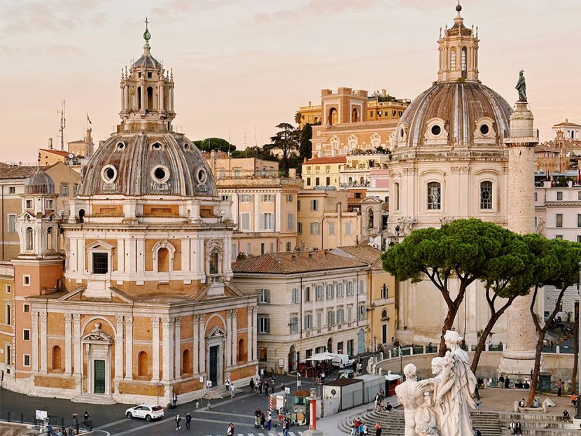 Pedestrians populate a city square in Rome, Italy.