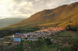 Buildings are scattered on the side of a mountain.