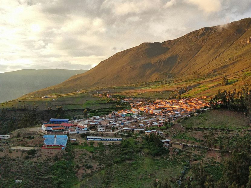 Buildings are scattered on the side of a mountain.