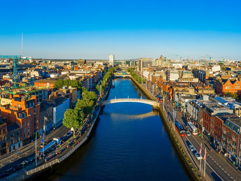 A bridge connects two sides of a city across a river.