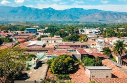Aerial view of buildings against a mountainous landscape.