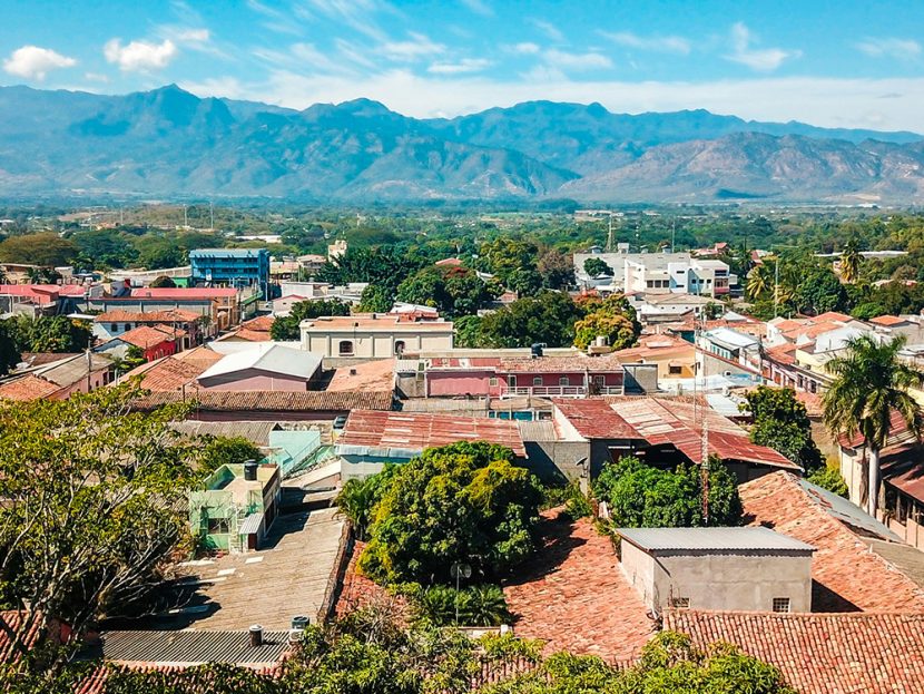 Aerial view of buildings against a mountainous landscape.
