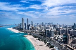 Tall city buildings along a beach.