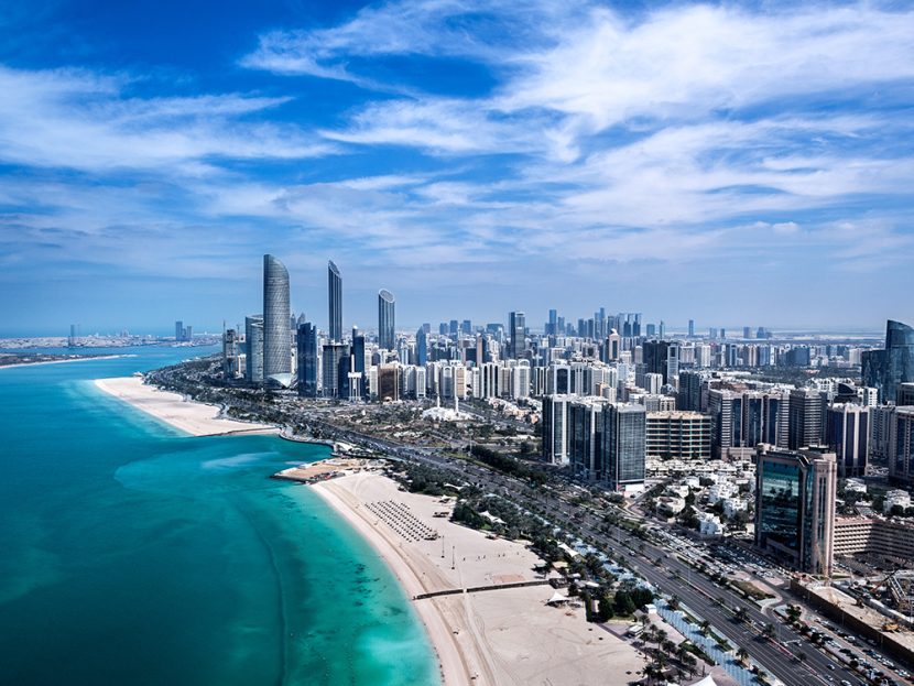Tall city buildings along a beach.