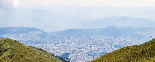 A view of a city from the top of a hill.