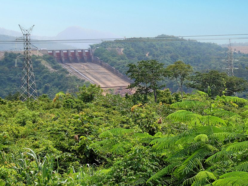 A hydro-electricity dam surrounded by lush vegetation.