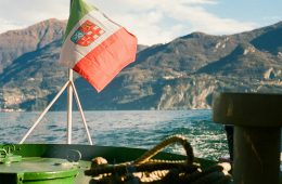 The red-and-green flag flies attached to a boat.