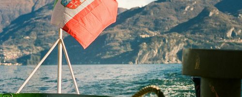 The red-and-green flag flies attached to a boat.