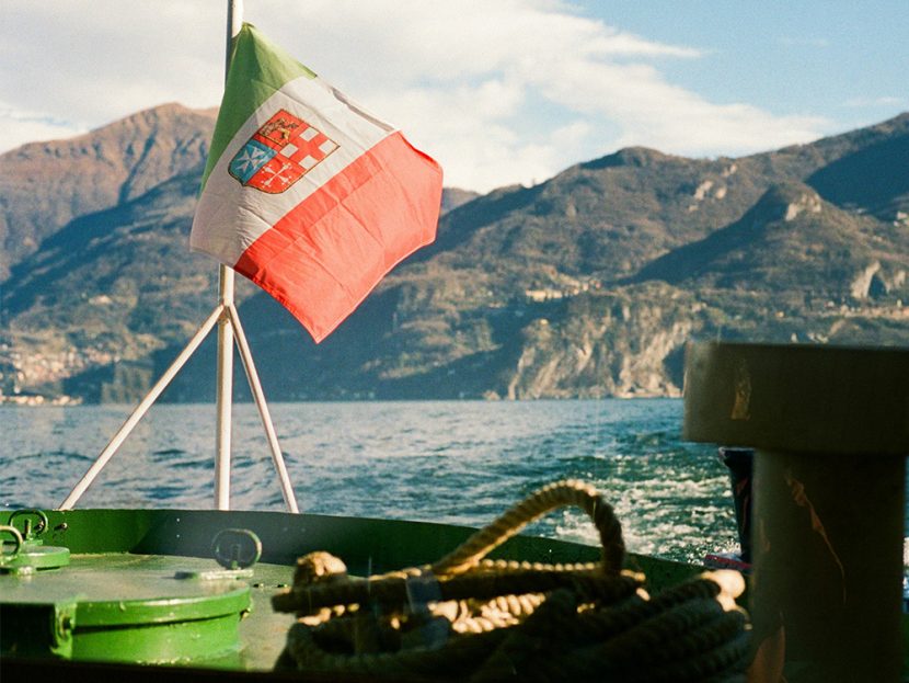 The red-and-green flag flies attached to a boat.