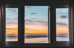 A view of a beach through a window.