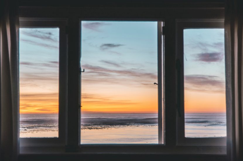 A view of a beach through a window.