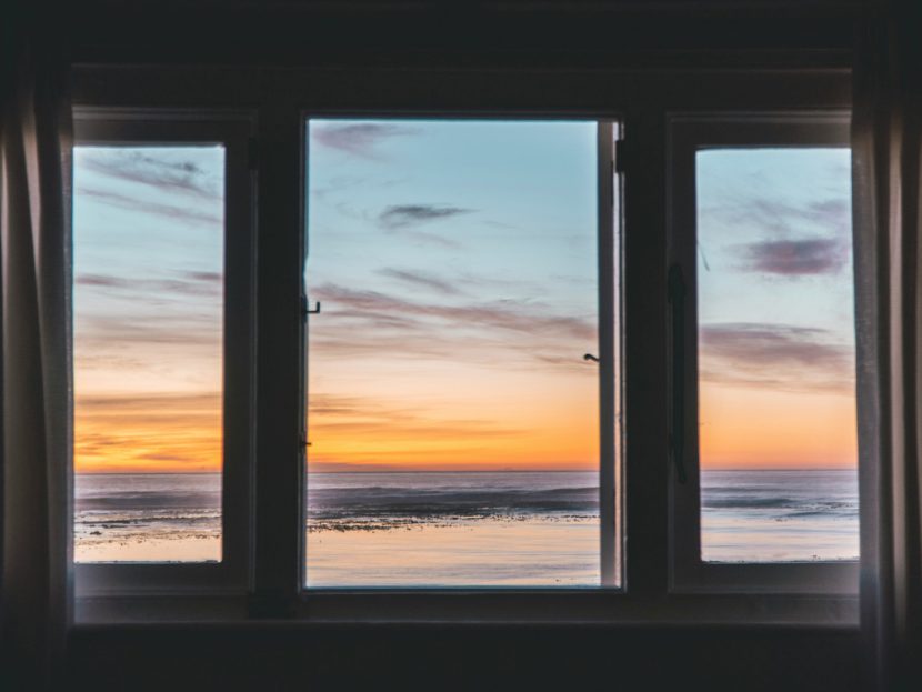 A view of a beach through a window.