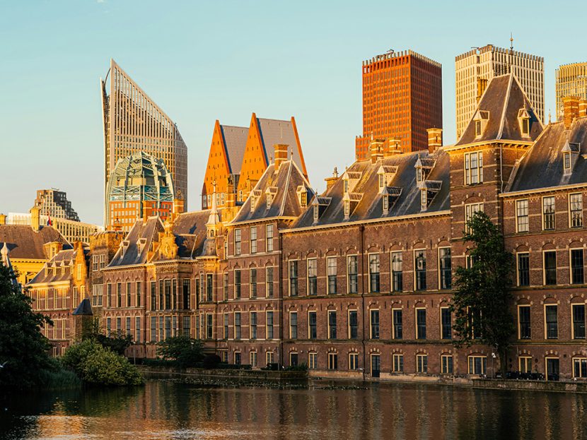 The setting sun glows upon buildings in a city.