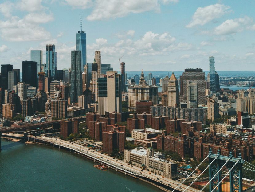 View of city buildings next to a river.