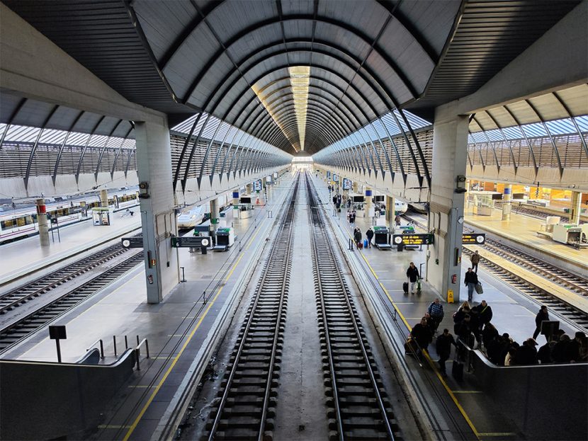 Travellers are seen in a train station.
