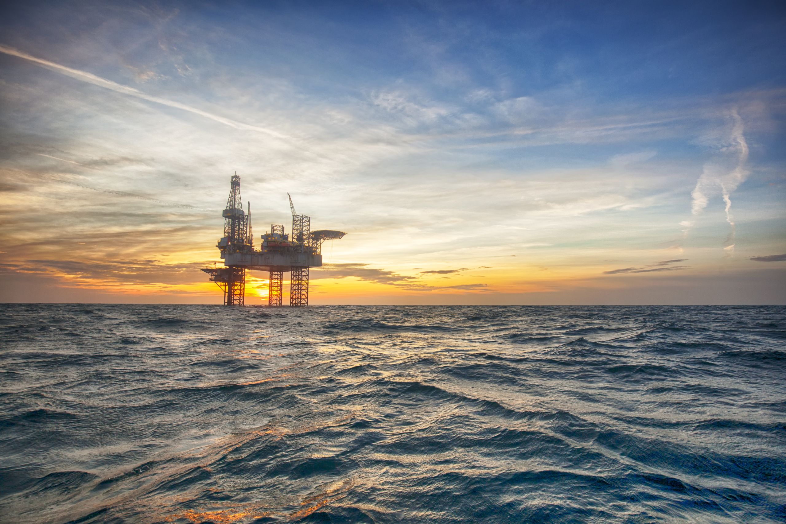 Offshore oil platform at sunset