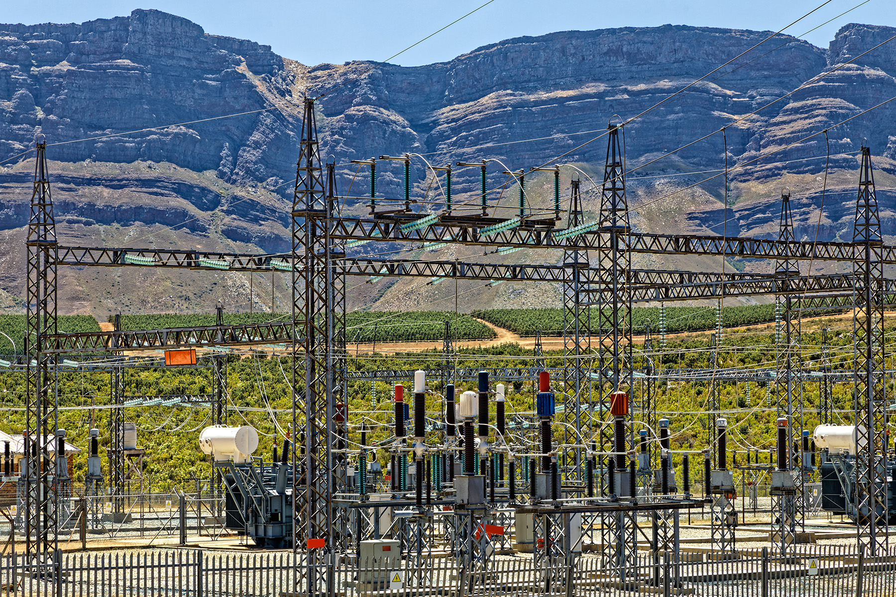 Electrical substation with mountains in the background.