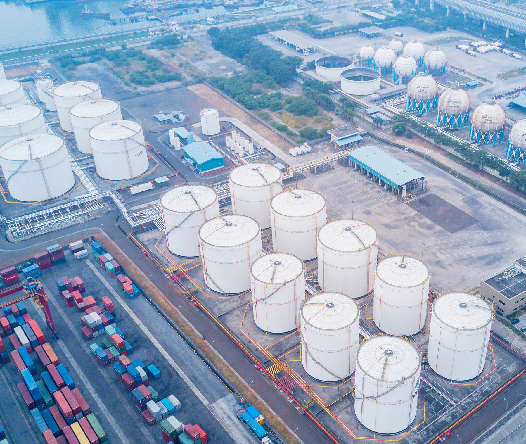 High level view of shipping crates and oil storage tanks.
