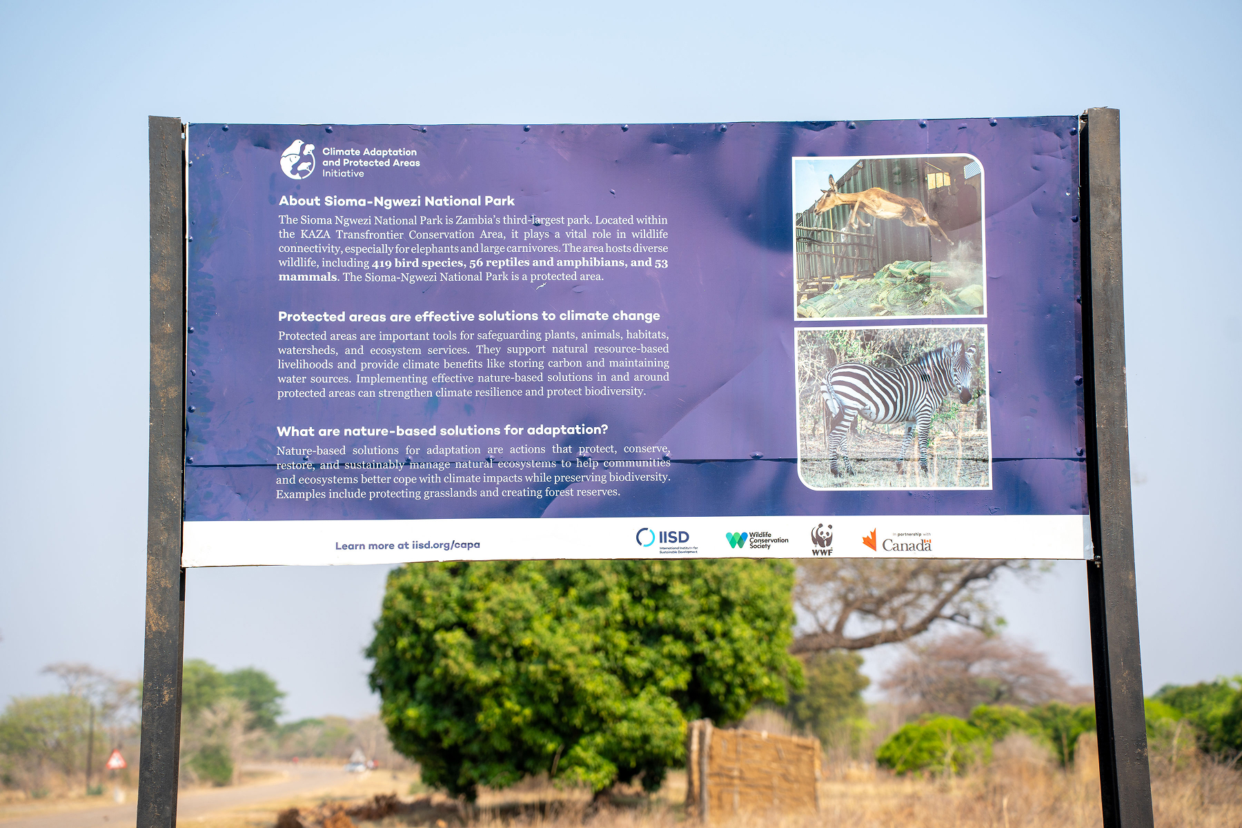 A large sign about Sioma-Ngwezi National Park covering climate change and nature-based solutions