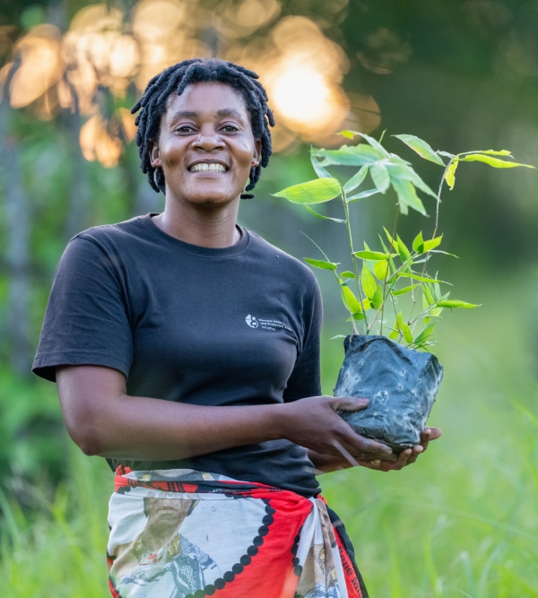 Portrait of Dafina Mwanza holding a plant