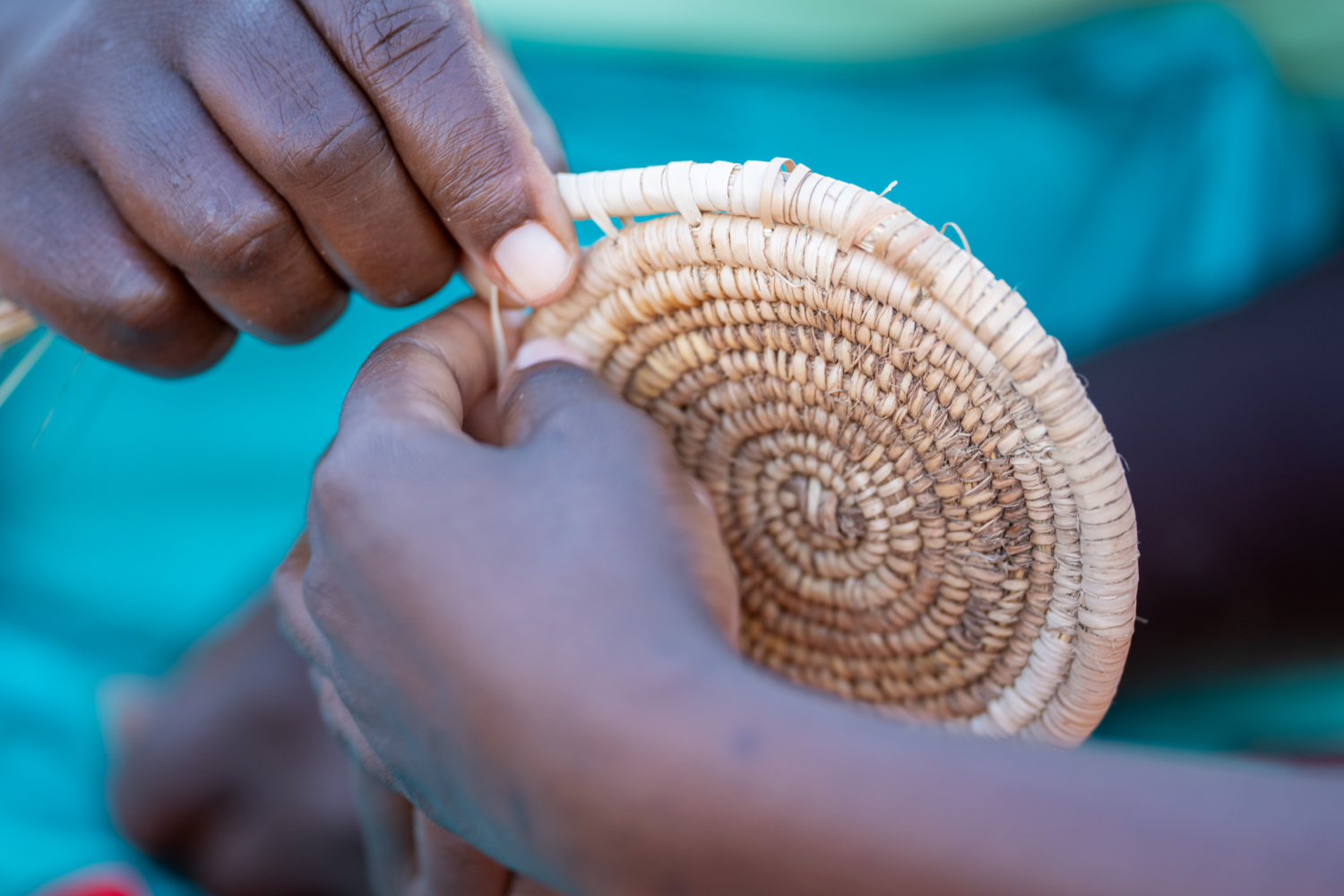Upclose shot of hands crafting a spiral straw art
