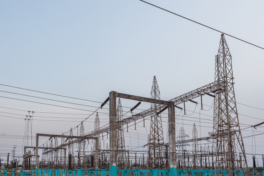 Electricity power substation in Chennai India, where electrical power is generated, transmitted, and distributed to systems. Photographed during sunset with low lighting conditions.