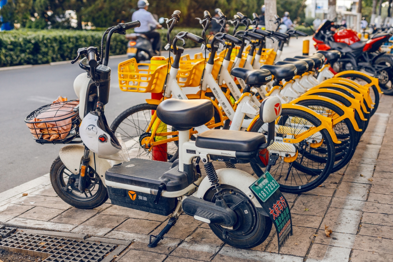 Line up of white electric scooters on streets of china