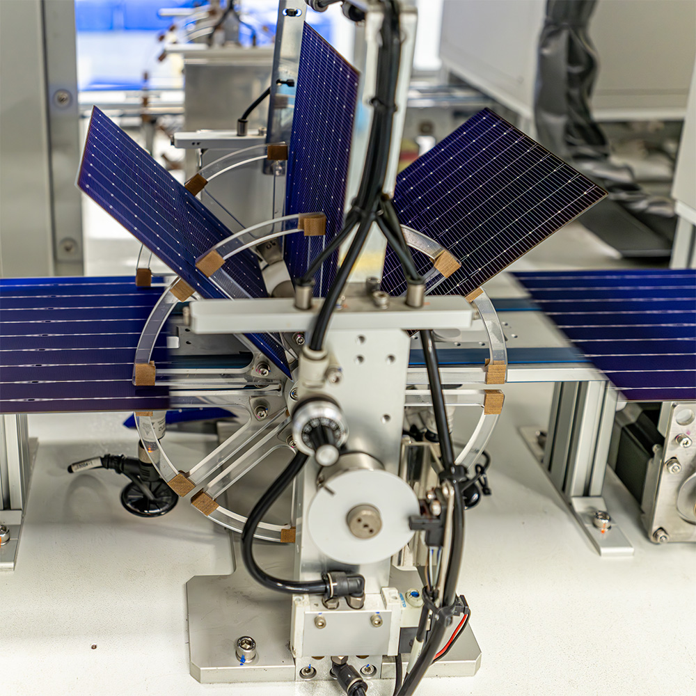 Solar panels transported down an assembly line.