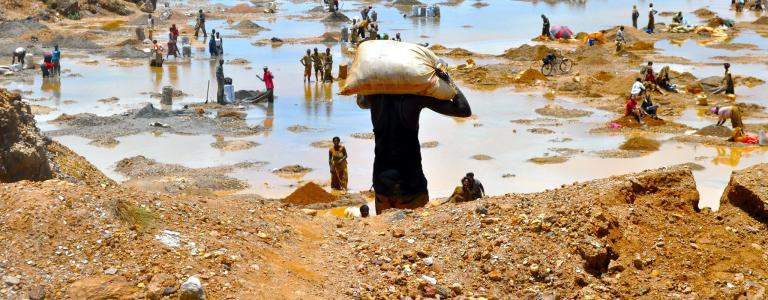 People wash copper ore at a mine in Congo