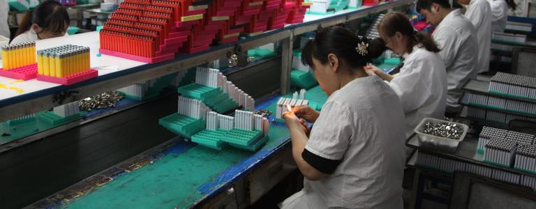 Workers assembling and testing lighters in factory in China