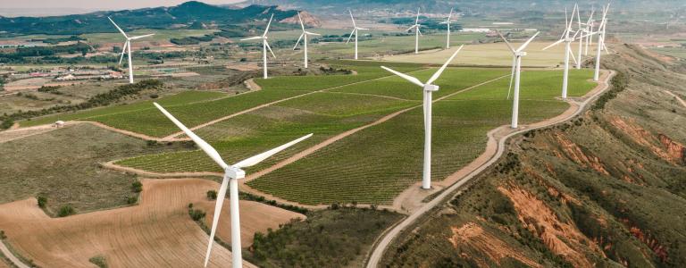 An aerial view of wind turbines on a hill top in Spain