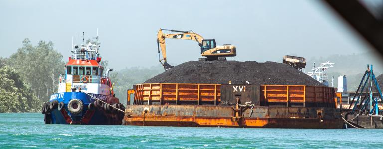 A tugboat ready to be loaded with coal at a harbour in Indonesia.