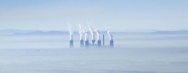 A coal fired power plant in South Africa near a river.