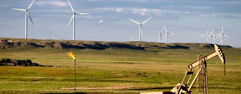 Wind turbines and an oil pump in the prairies.