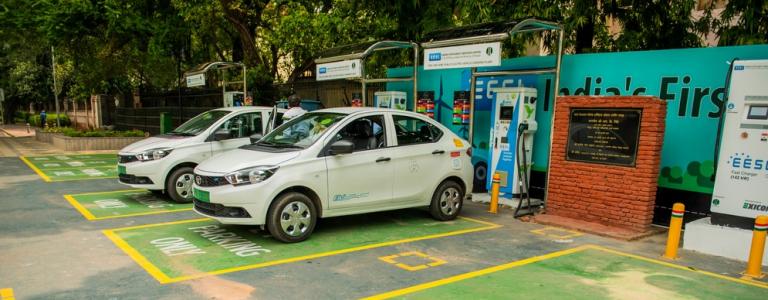 Drivers charging their electric cars at the charging stations around government offices in India.